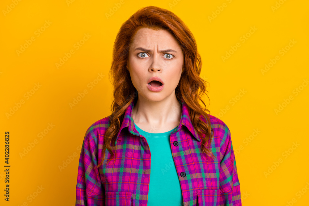 Photo of shocked negative lady staring open mouth wear checkered purple isolated on yellow color background Photo of shocked negative lady staring open mouth wear checkered purple isolated on yellow color background