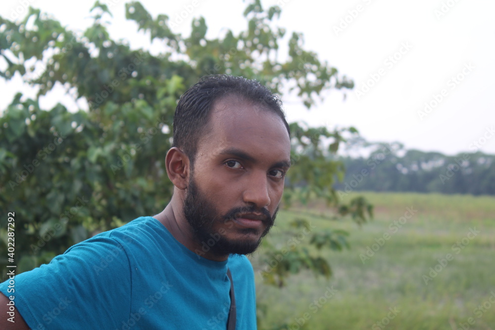 Portrait of handsome runner with beard in nature