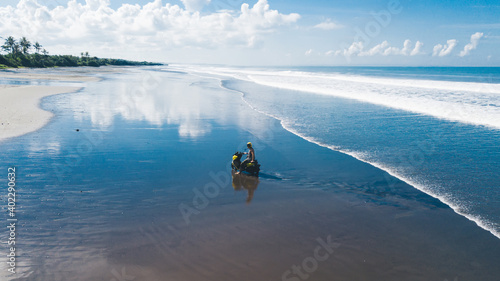 Unrecognizable male biker sitting on scooter among sea