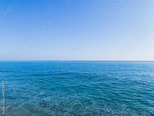 Blue sea and clear blue sky background © Oksana