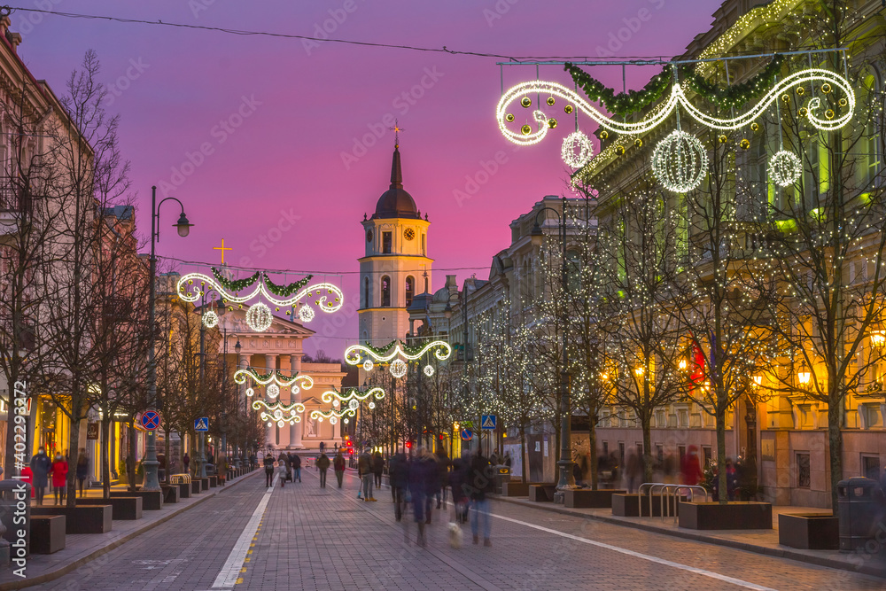 Evening in the Gediminas avenue, crouds of people walking in the streets. Time lapse of Christmas Time In Vilnius, Lithuania