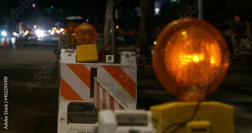 Flashing yellow warning lights in a construction zone at night