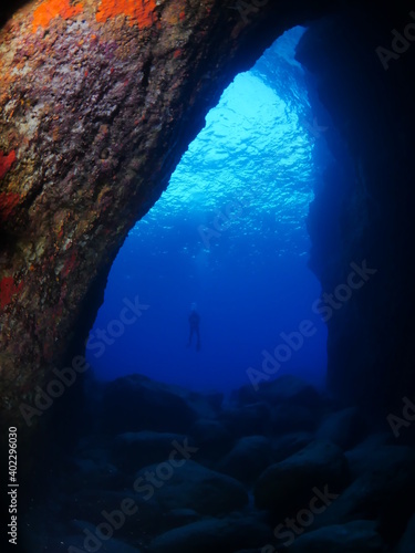 cave diving underwater scuba divers exploring caves and having fun ocean scenery sun beams and rays background