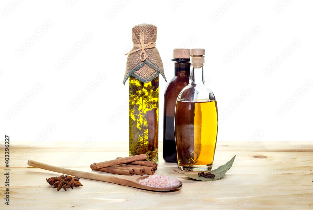 The seasonings, olive oil and vinegar on a wooden table The seasonings, olive oil and vinegar on a wooden table
