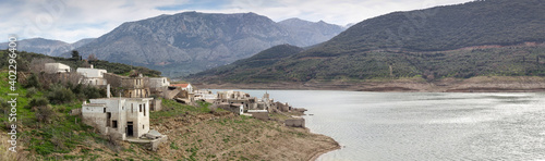 Deserted village on a lake surrounded by mountains (Crete, Greece) © TETYANA