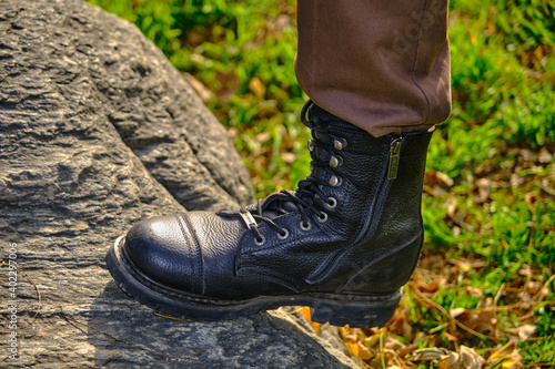 Military protective boots on the rock and agricultural yard in the village.Bursa. Turkey