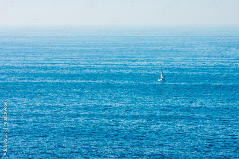 sailboat sailing in the middle of the ocean