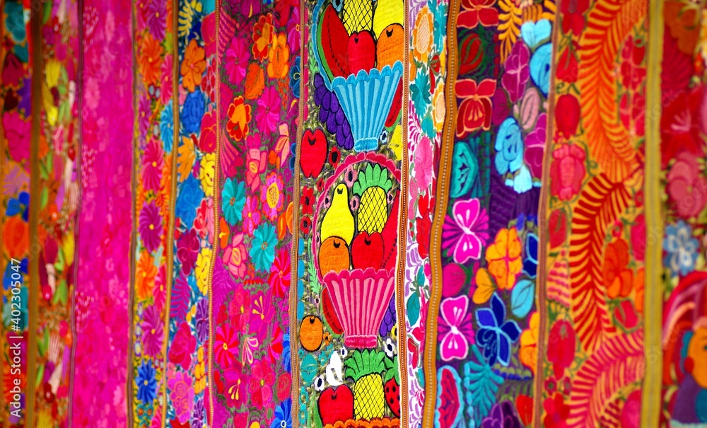 Fototapeta premium Colorful market with beautiful and unuque handicraft fabric patterns available in Otavalo, Ecuador 
