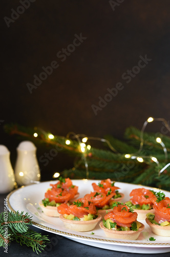 Snack with salmon and avocadon on New Year's table. photo