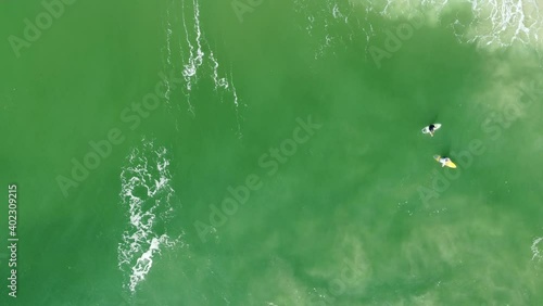 surfers waiting for good surf on the lineup at surfers paradise goldcoast