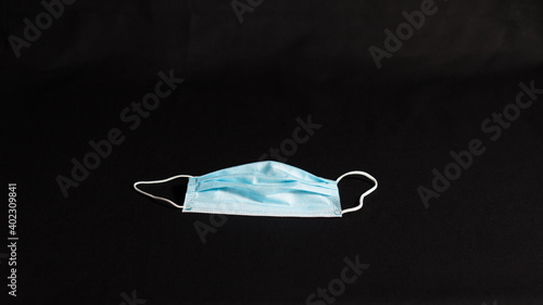 A surgical mask isolated on black background. 