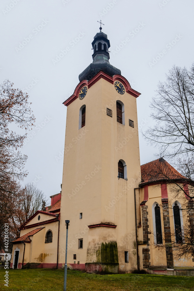 Baroque Church of Saint Wenceslas, Narrow picturesque street, Chapel at main square in Budyne nad Ohri in winter day, Northwest Bohemia, Czech Republic