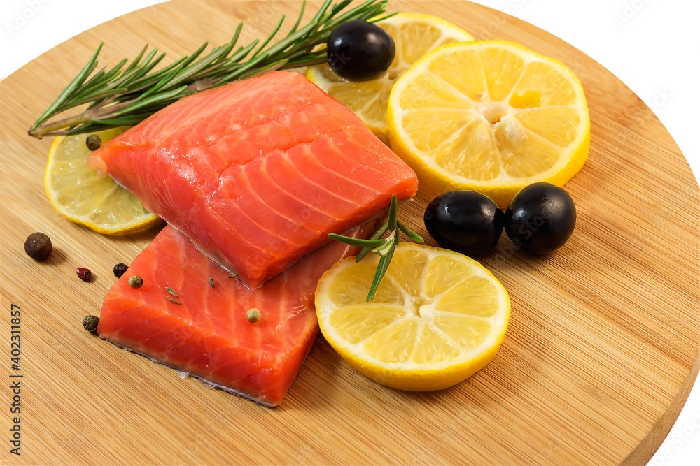 Pieces of lightly salted red fish with lemon, olives, spices on a cutting kitchen board. Pieces of lightly salted red fish with lemon, olives, spices on a cutting kitchen board.