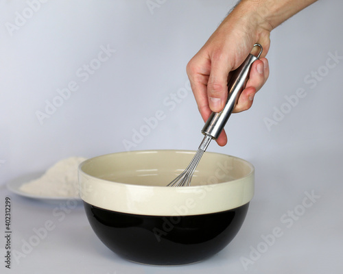Whisking in a cooking bowl close up of hand