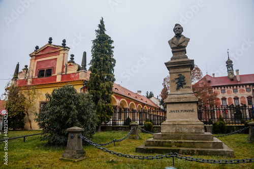 Monument to Jan Evangelista Purkyne near Castle Libochovice with French style park and garden, Romantic baroque chateau in winter day, Litomerice district, Bohemia, Czech Republic