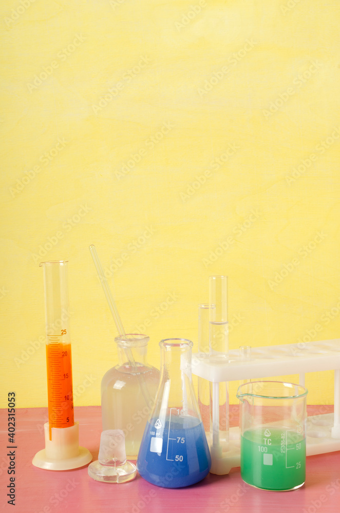 Vertical image.Lab glassware full of chemical reagents.Fun chemistry.Empty space