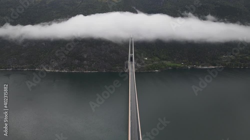 Areal footage of one of the longest suspension bridges in the world.  A cloud over the bridge. Western Norway, Hardanger bridge photo