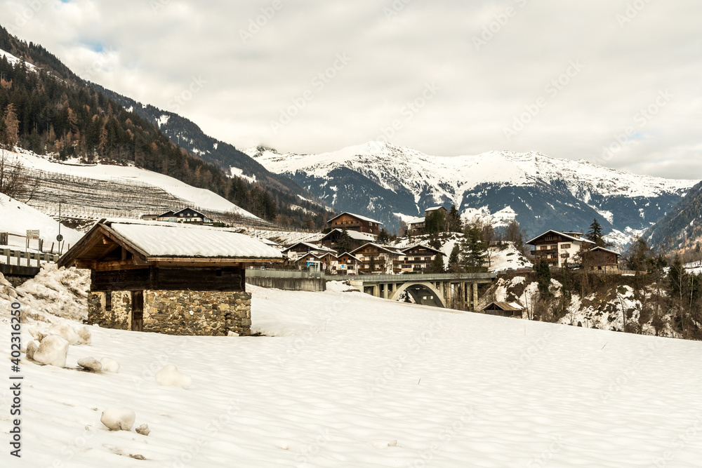 The small village San Martino in Passiria (St. Martin in Passeier in german) covered in snow, with alps mountains, South Tyrol, Alto Adige, Südtirol, Italy.
