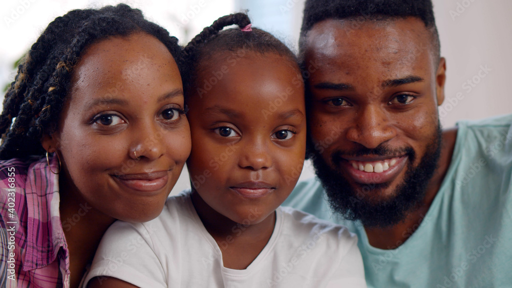 Close up portrait of joyful african american parents with cute preteen daughter Close up portrait of joyful african american parents with cute preteen daughter