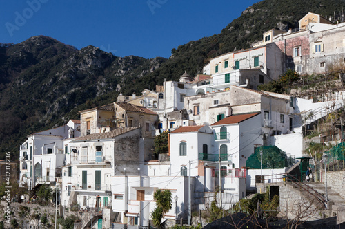 view of the village of Albori, with its characteristic white houses immersed in the Mediterranean vegetation, on the Amalfi coast, south of Italy. © Francesca
