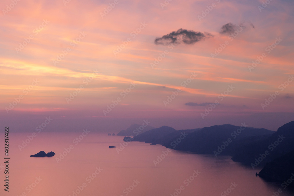 Obraz premium Panorama view of Mediterranean Sea at famous Amalfi Coast in beautiful pink evening light at sunset. Campania, Italy.