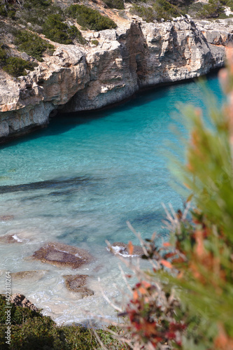 Glimpse of the beautiful beach "Caló des Moro" immersed in  the Mediterranean scrub  with crystal clear water, Majorca (Mallorca) Balearic Islands, Spain, Europe. © Francesca