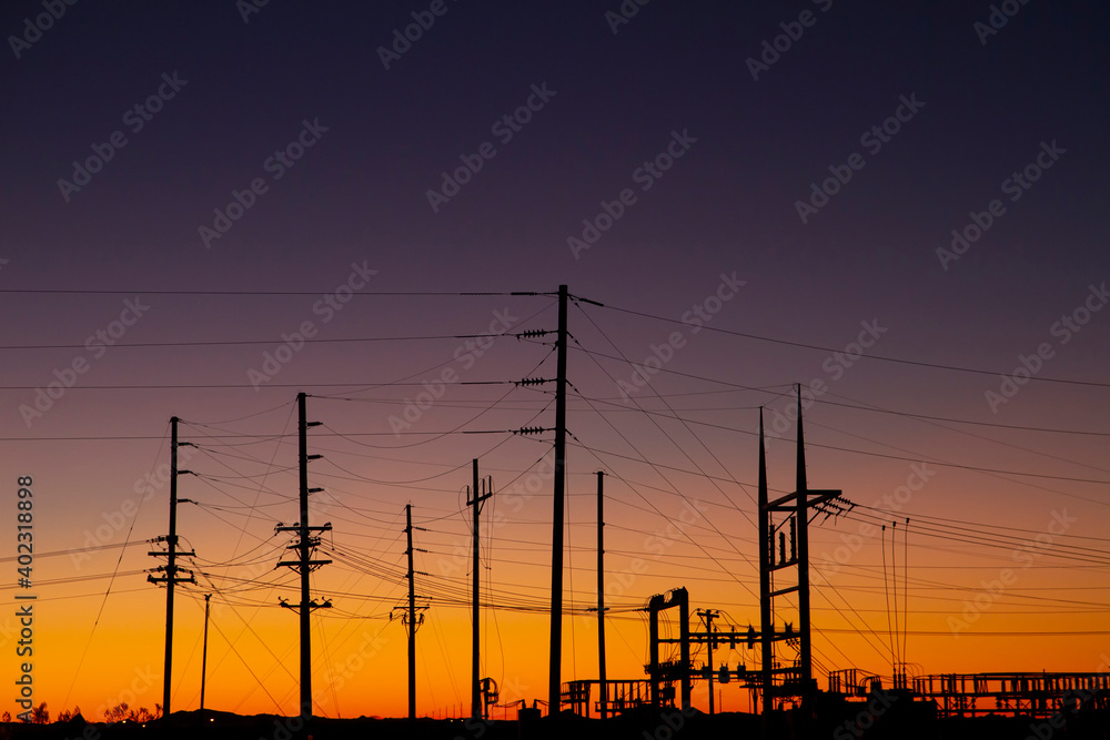 Silhouette of Power Station with Transmission Towers at Sunset