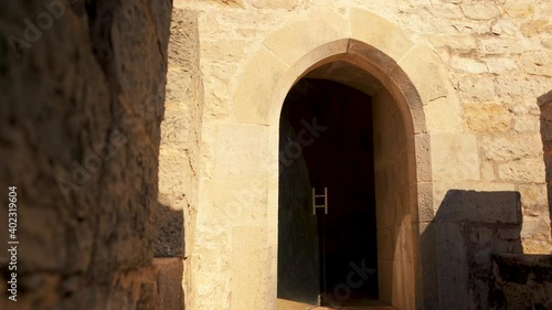 Portugal Loule stone wall reveal castle door in truck camera movement at sunshine 4K photo