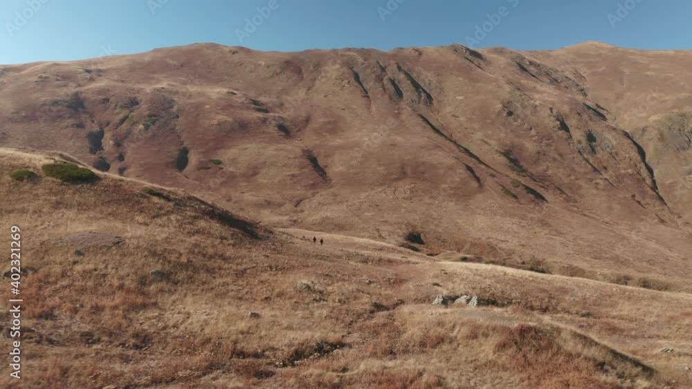 Aerial panoramic view from above two active woman going at hilly mountain area valley. Hiker female enjoying travel adventure trekking feeling freedom and inspiration 4k. Aerial panoramic view from above two active woman going at hilly mountain area valley. Hiker female enjoying travel adventure trekking feeling freedom and inspiration 4k.