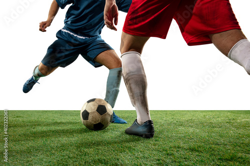 Attack. Close up legs of professional soccer, football players fighting for ball on field isolated on white background. Concept of action, motion, high tensioned emotion during game. Cropped image. © master1305
