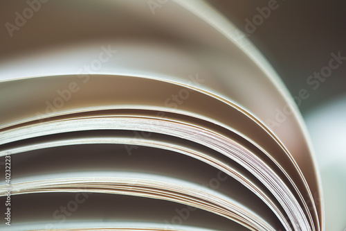 Black and White image of an open book with pages curved. photo