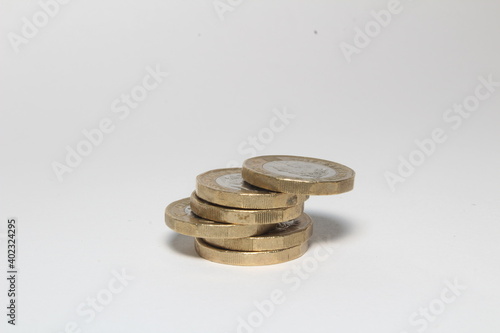 Foto New one pound sterling coins isolated in white background, British currency moni