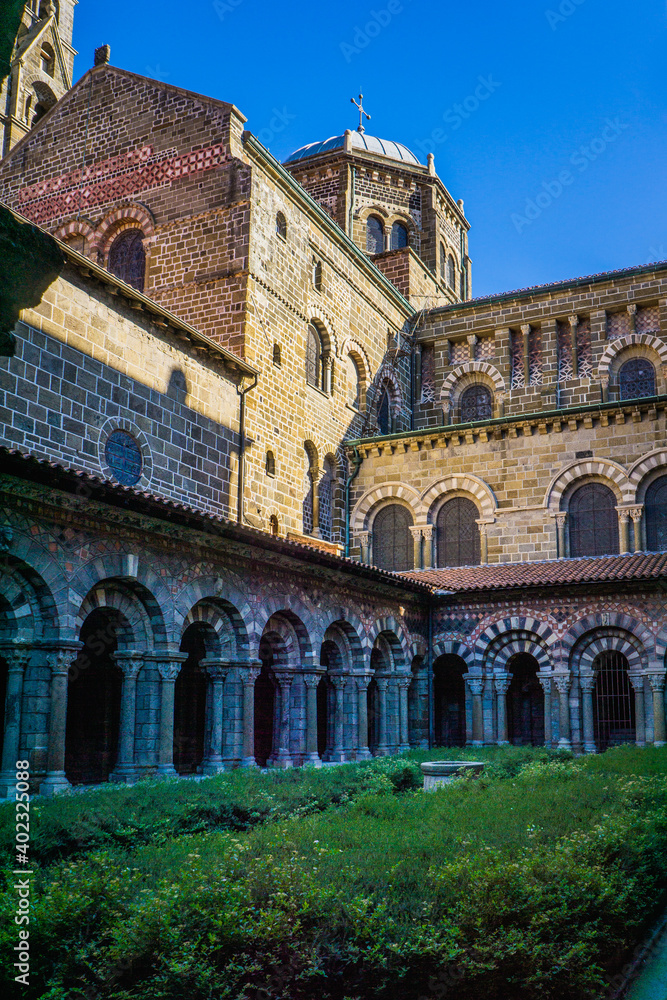 The 12th century cloister of Notre Dame cathedral in le Puy en Velay (Auvergne, France) is a medieval wonder with its amazing romanesque and colorful architecture