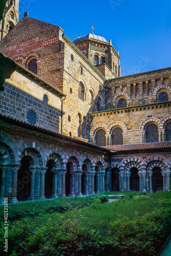 The 12th century cloister of Notre Dame cathedral in le Puy en Velay  Auvergne  France  is a medieval wonder with its amazing romanesque and colorful architecture