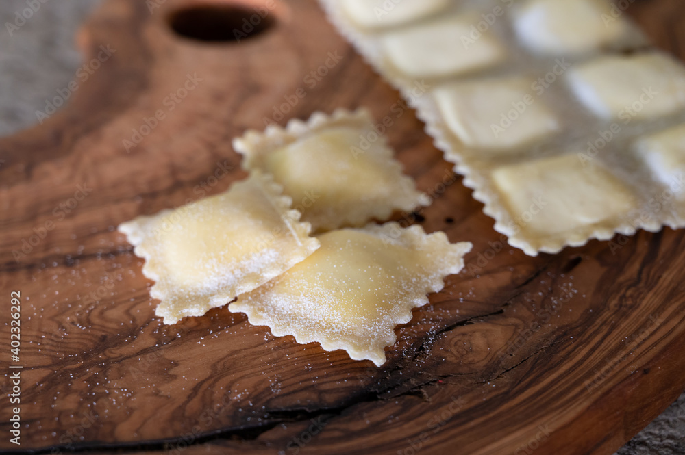 Handmade uncooked fresh ravioli with four cheeses filling, tasty vegetarian food Handmade uncooked fresh ravioli with four cheeses filling, tasty vegetarian food