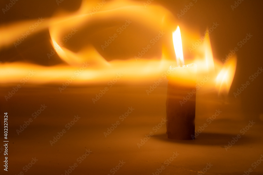 Photo of a burning candle with a yellow flame	