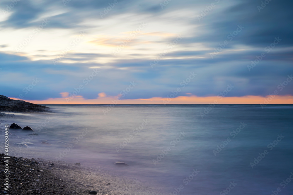Cloudy winter sunset over the Baltic Sea at island of Gotland, Sweden
