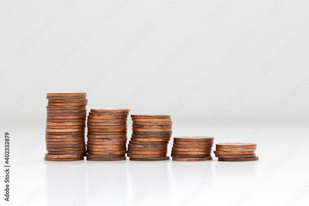 Side view of stacks of coins increasing in height, on white studio background isolated, business and financial concept Side view of stacks of coins increasing in height, on white studio background isolated, business and financial concept