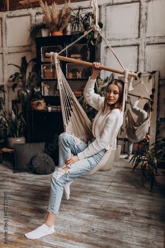 Studio photo. Girl in a white sweater and jeans.