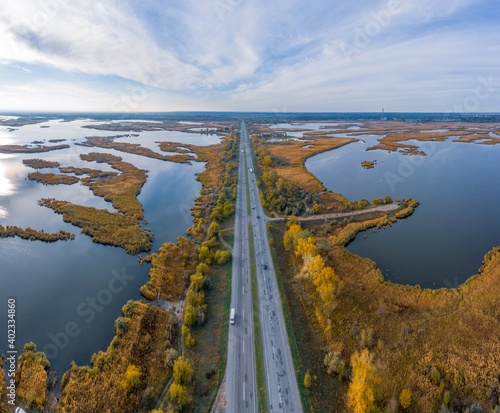 The road passes through the Samarskie Plavni picturesque Ukraine in the evening light photo