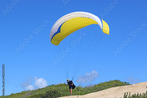 Paraglider launching above Victory Walls beach, Portugal 