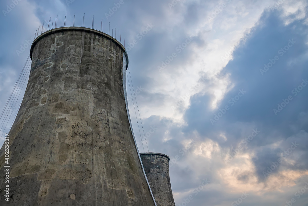 incredibly huge, industrial chimney made of concrete blocks. Concept of preserving the environment and taking care of nature incredibly huge, industrial chimney made of concrete blocks. Concept of preserving the environment and taking care of nature