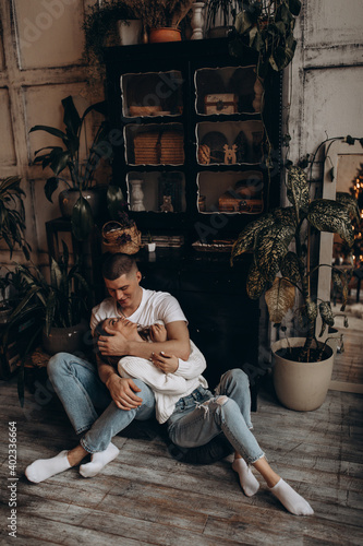The guy hugs his girlfriend. A loving couple in a cozy home environment. Studio photography.