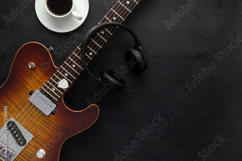 Desk of musician for songwriter work set with headphones and guitar