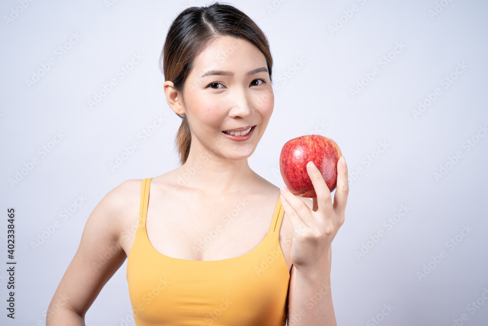 Smiling Asian woman holding red apple Isolated on white background. Smiling Asian woman holding red apple Isolated on white background.