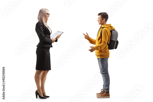 Full length profile shot of a teenage male student talking to a businesswoman
