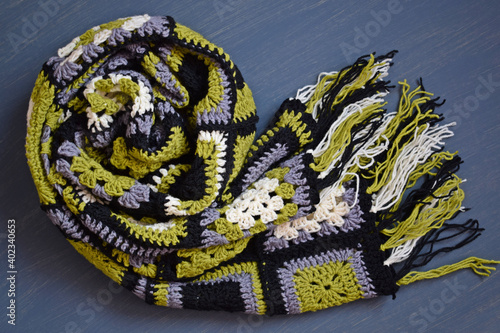 Knitted scarf in the patchwork style.The scarf is made of colored squares.