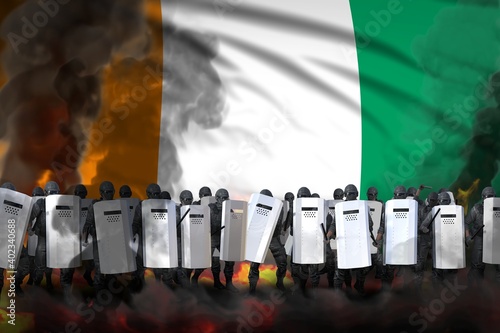 Cote d Ivoire protest fighting concept, police officers in heavy smoke and fire protecting peaceful people against disorder - military 3D Illustration on flag background