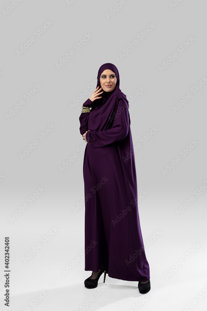 Young. Beautiful arab woman posing in stylish hijab isolated on studio background with copyspace for ad. Fashion, beauty, style concept. Female model with trendy make up, manicure and accessories.