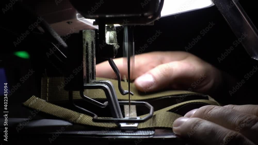 Slowmotion of a man making a military costume on the very complex sewing machine from the side. Very precise and detailed process. Slowmotion of a man making a military costume on the very complex sewing machine from the side. Very precise and detailed process.